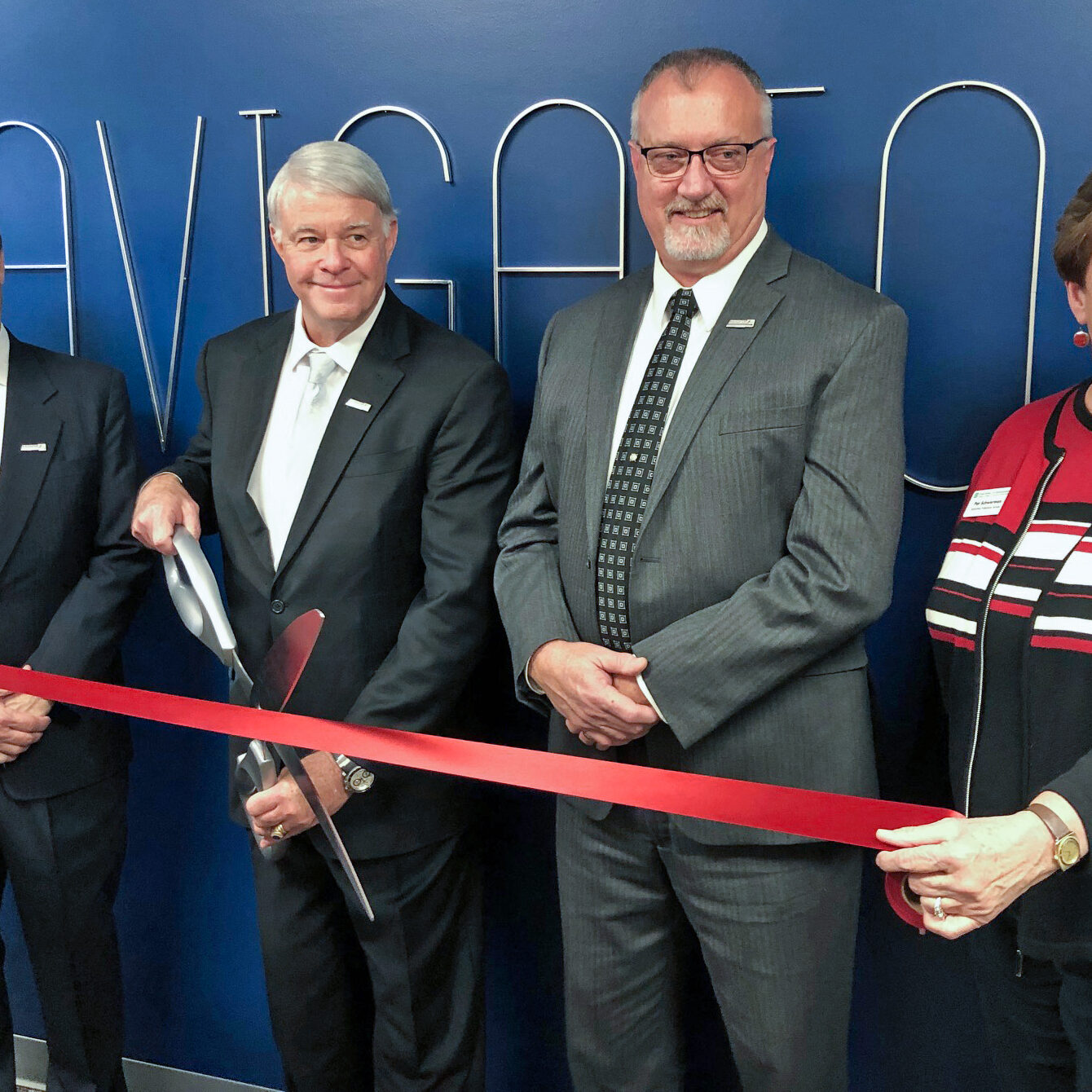 Cutting the ribbon - Jim Moentmann, Keith Gay, Tim Wright and Pam a volunteer with the Huntsville chamber - TIMELINE